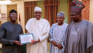 PHOTOS OF THE DAY: Fayemi presents Certificate of Return to Buhari